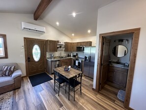 A compact kitchen with wooden cabinets, a built-in oven, and a refrigerator. - Cozy guest cabin (Kalispell)