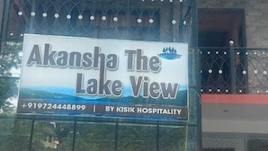 A building with a sign for "Akansha The Lake View" by Kisik Hospitality. - Akansha The Lake View (Nainital)