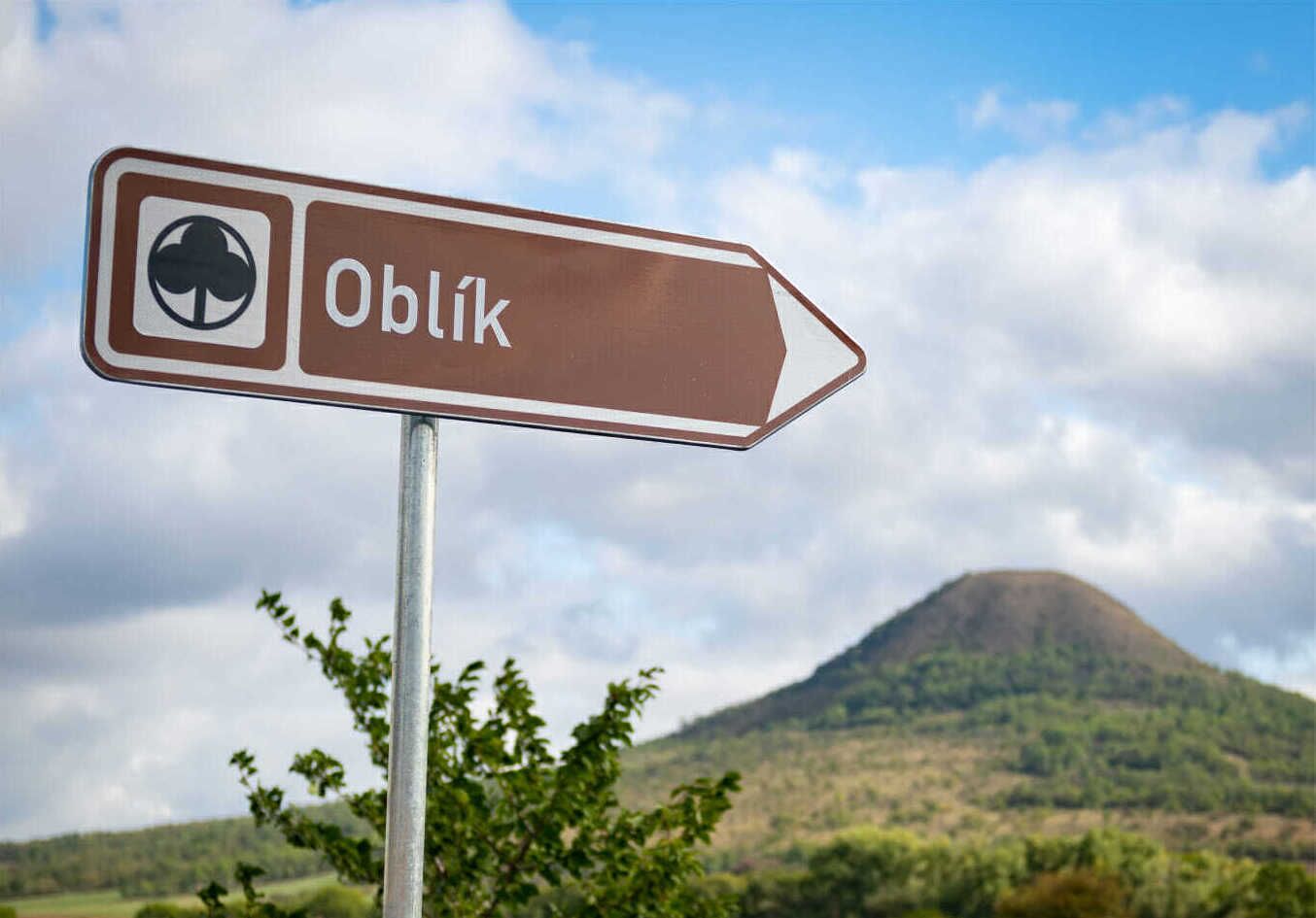Suuntamerkki, jossa on sana ”Oblik” ja apilan kuvake.