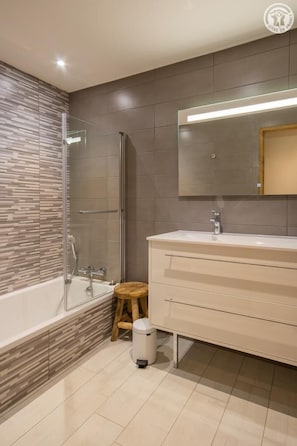 A modern bathroom with a glass-enclosed shower, a white vanity with a mirror, and a tiled floor. - Chalet Panoramic - Valloire (VALLOIRE)