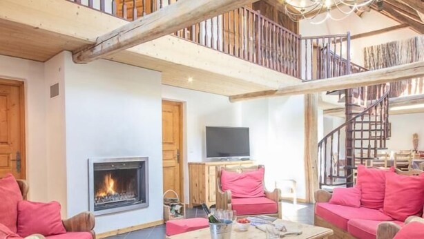 A spacious living room with a fireplace, red sofas, a wooden coffee table, and a TV. - Chez LE Marquis DU Pontet 5 (VALLOIRE)