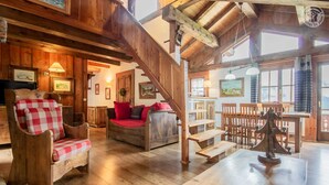 A wooden interior with a staircase, wooden furniture, and a dining area. - Chalet Bellacomba-grd Paradis (SAINTE FOY TARENTAISE)