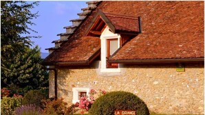 A stone building with a tiled roof, a small window, and a sign reading "LA GRANGE". - LA Grange - Traize - Gîte (TRAIZE)