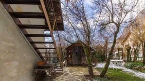 A rustic wooden building with a stone staircase leading to a wooden deck. - UN Loft A LA Campagne (SAINT JEAN D'ARVEY)