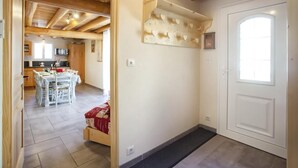 A spacious kitchen with modern appliances, a dining area with a table set for four, and a wooden ceiling. - Chalet DES Alpes - Val-cenis (VAL CENIS)