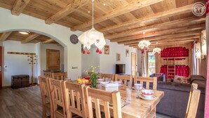 A wooden dining area with a table set for four, surrounded by wooden chairs. - LA Pastourelle 2 - Bonneval SUR ARC (BONNEVAL SUR ARC)
