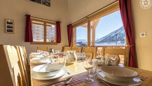 Taula de dinar per a quatre amb vista a una muntanya nevada.