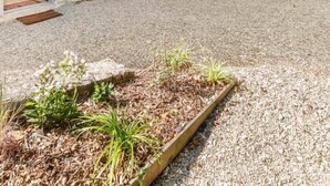A rustic stone building with a gravel courtyard, outdoor seating, and a barbecue grill. - Clos DES Platanes-cote Figuier (BRISON SAINT INNOCENT)
