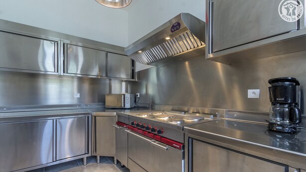 A modern kitchen with stainless steel appliances, a built-in oven, and a coffee maker. - DE Saint Jean Baptiste (BEAUFORT ARECHES)
