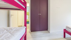 A bedroom with a bunk bed, a wardrobe, and a door leading to another room. - DE Saint Jean Baptiste (BEAUFORT ARECHES)
