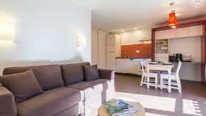 A modern apartment with a living area, kitchenette, and dining space. - LA Lauziere - Montsapey (MONTSAPEY)
