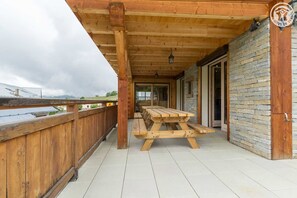 Enjoy outdoor dining or relaxation on the deck with a large picnic table and comfortable seating.
