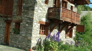 A stone building with wooden balconies and windows.