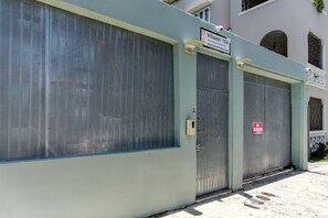 A gated building with a sign reading "Villamil 154" and a "No Trespassing" sign.