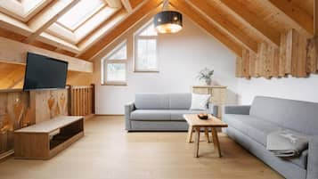 Grande with private sauna | Living area | 108-cm flat-screen TV with satellite channels, heated floors