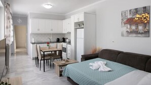 A compact living space with a kitchenette, a dining area, and a bed. - Detatched house - 1km from the beach. (KOS STATE - DODECANESE)
