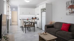A modern apartment with a dining area, kitchen, and living room. - Detatched house - 1km from the beach. (KOS STATE - DODECANESE)
