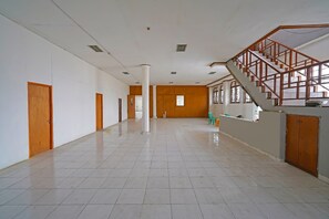 Staircase leads to an upper level, with doors and a tiled floor.