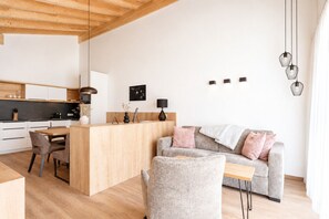A modern living space with a kitchen, dining area, and seating area.