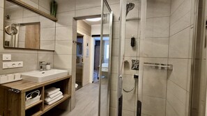Shower, hair dryer, towels, toilet paper