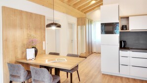 Una cucina moderna con mobili bianchi, un forno a microonde e una macchina per il caffè.