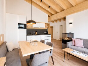 A modern interior with a dining area, kitchen, and living space.
