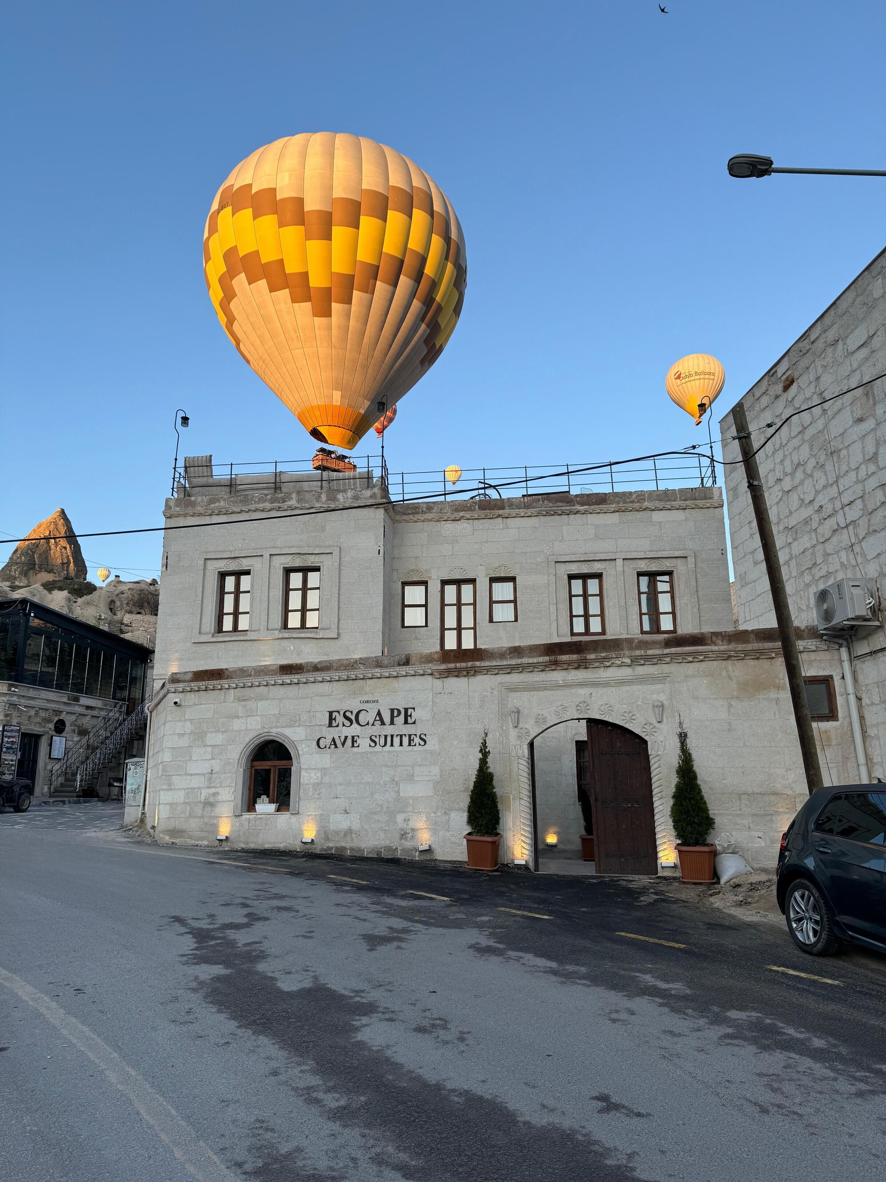 A building labeled "Escape Cave Suites" with a street in front.