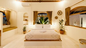 A well-lit bedroom with a large bed, a window with curtains, a ceiling fan, and a potted plant. - Canggutopia by Alfred in Bali (Canggu)