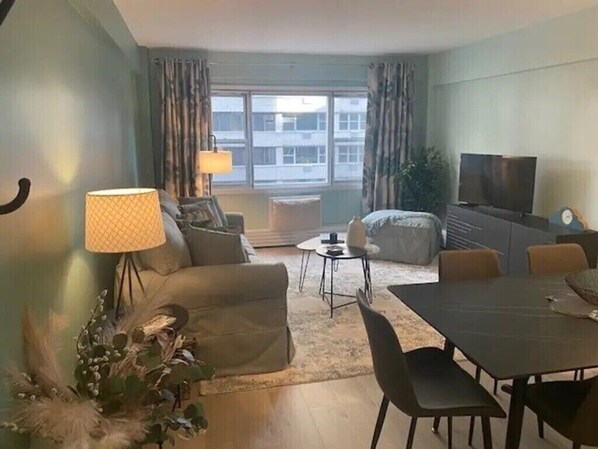 Relax in this inviting space with a comfortable sofa, dining table, and flat-screen TV.