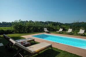 Seasonal outdoor pool, pool loungers