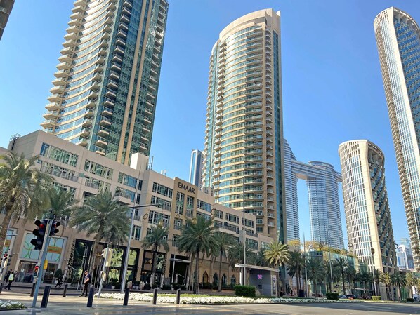 A modern high-rise building with a curved facade, multiple balconies, and a prominent EMAAR sign. - Silkhaus Lofts, Downtown Dubai (Dubai)