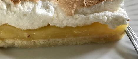 A slice of cake with a golden crust on a white plate.