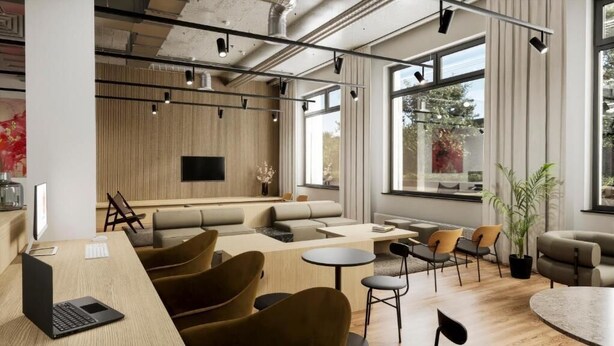 A modern lounge area with seating, a flat-screen TV, and large windows. - Habyt Berlin Waterfront (Berlin)