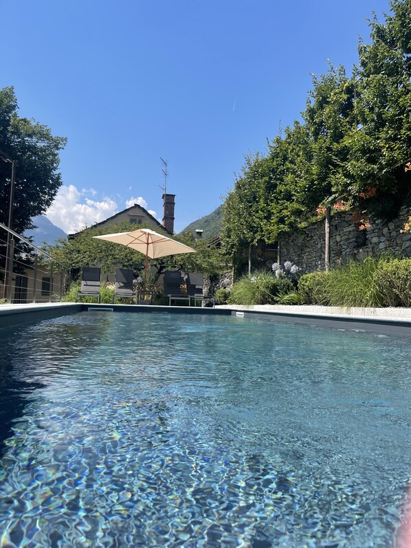 Seasonal outdoor pool, open 9:00 AM to 6:00 PM, pool umbrellas