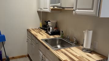 Fridge, microwave, coffee/tea maker, cookware/dishes/utensils