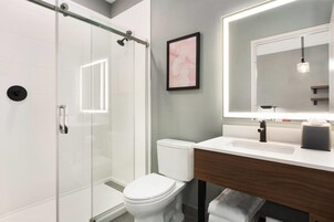 2 Queen Beds, Deluxe Room, Sofa Bed, Non-Smoking | Bathroom | Hair dryer, towels, soap, shampoo