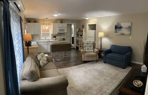 Relax in this open-plan living space with a large sofa and dining area.