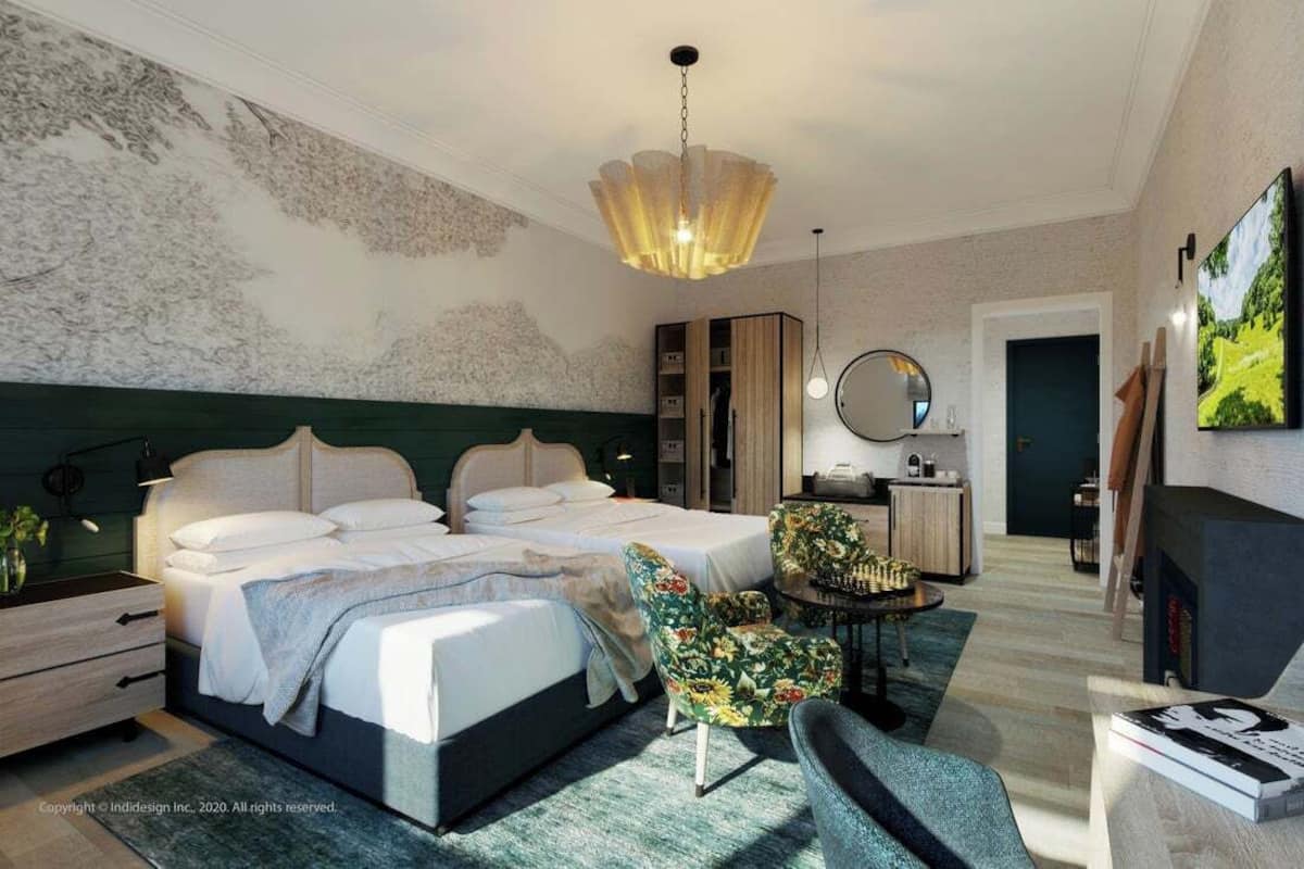 A modern hotel room with a large bed, a desk, a chair, and a television.