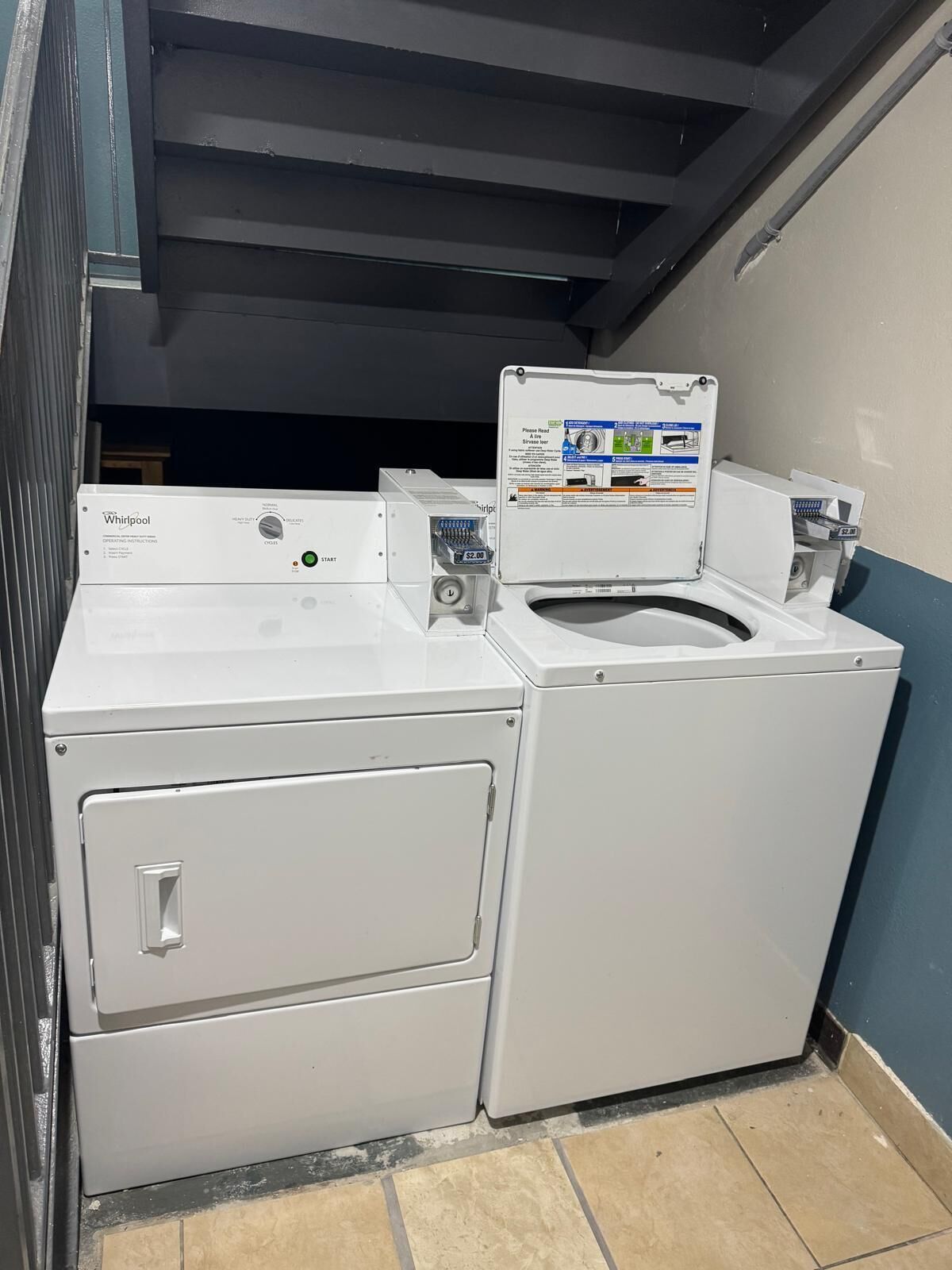 A Whirlpool front-loading washer and dryer unit with a control panel and a price tag of $2.00.