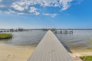 A pier extending into calm water with a clear sky above. - 10 Mi to Navarre Beach! Waterfront Rental w/ Pool (Mary Esther)