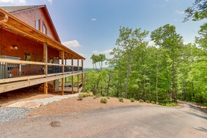 A wooden cabin with a covered porch, surrounded by a forest and a clear sky. - Blue Ridge Vacation Rental w/ Deck & Game Room! (Blue Ridge)