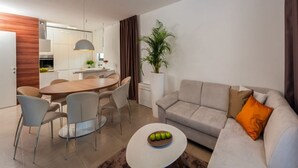A modern living room with a sofa, coffee table, and dining area. - Villa Panda - Six Bedroom Villa, Sleeps 11 (Okrug Gornji)