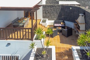 A rooftop patio with a dining area, seating, and a barbecue grill. - Lanzarote Lauren - Four Bedroom Villa, Sleeps 9 (Playa Blanca)