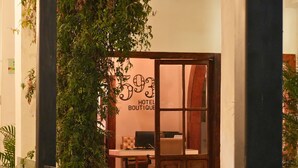 A hotel boutique with a wooden door, a desk with a computer, and a wall with the number 593.