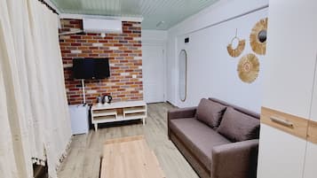 Design Apartment, 1 King Bed with Sofa bed, Courtyard View, Garden Area | Living area | 82-cm Smart TV with satellite channels, TV