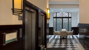 An elevator with digital displays, a check-in counter, a check-in desk, and a check-in area with a checkered floor. - 2 Minutes From Copacabana Beach Df408 (Rio de Janeiro)