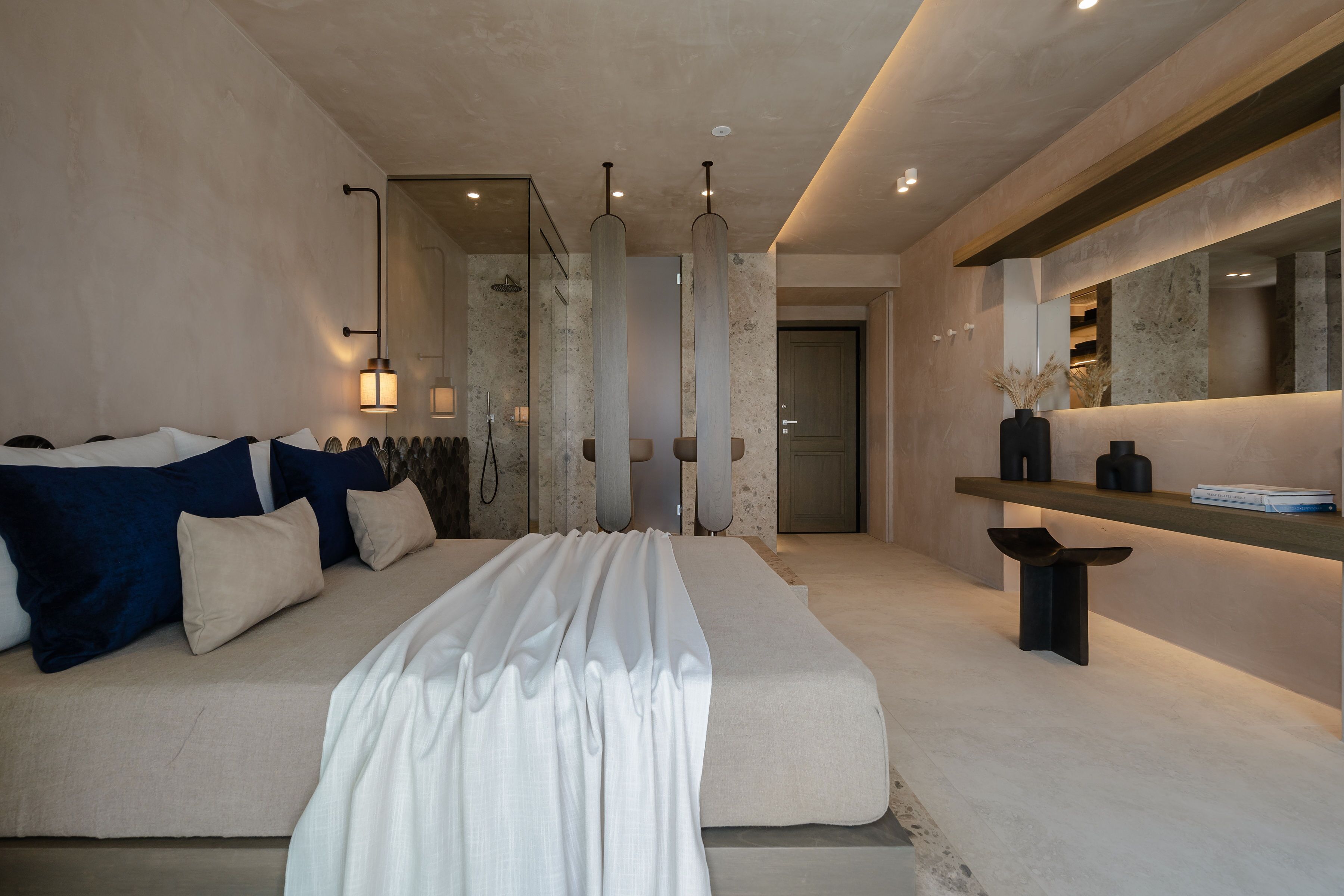 Une chambre moderne avec un grand lit, une table de chevet, un miroir et une étagère fixée au mur.