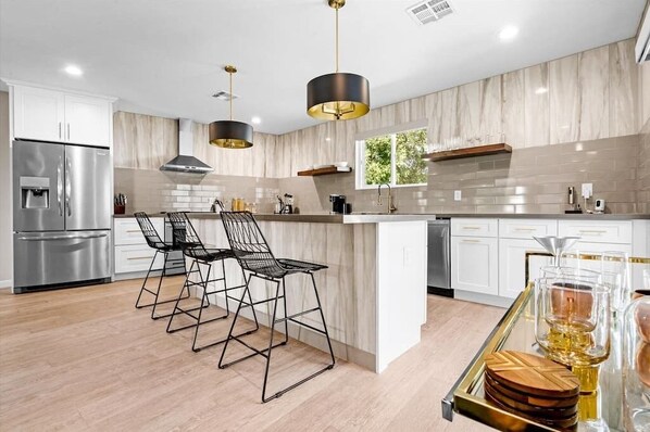 Enjoy cooking in this well-lit kitchen with a large island and oven.