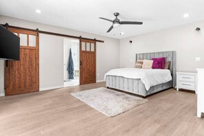 Relax in this serene bedroom with a large bed and comfortable seating area.