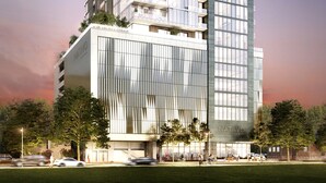 Um edifício moderno com fachada de vidro, com a inscrição 